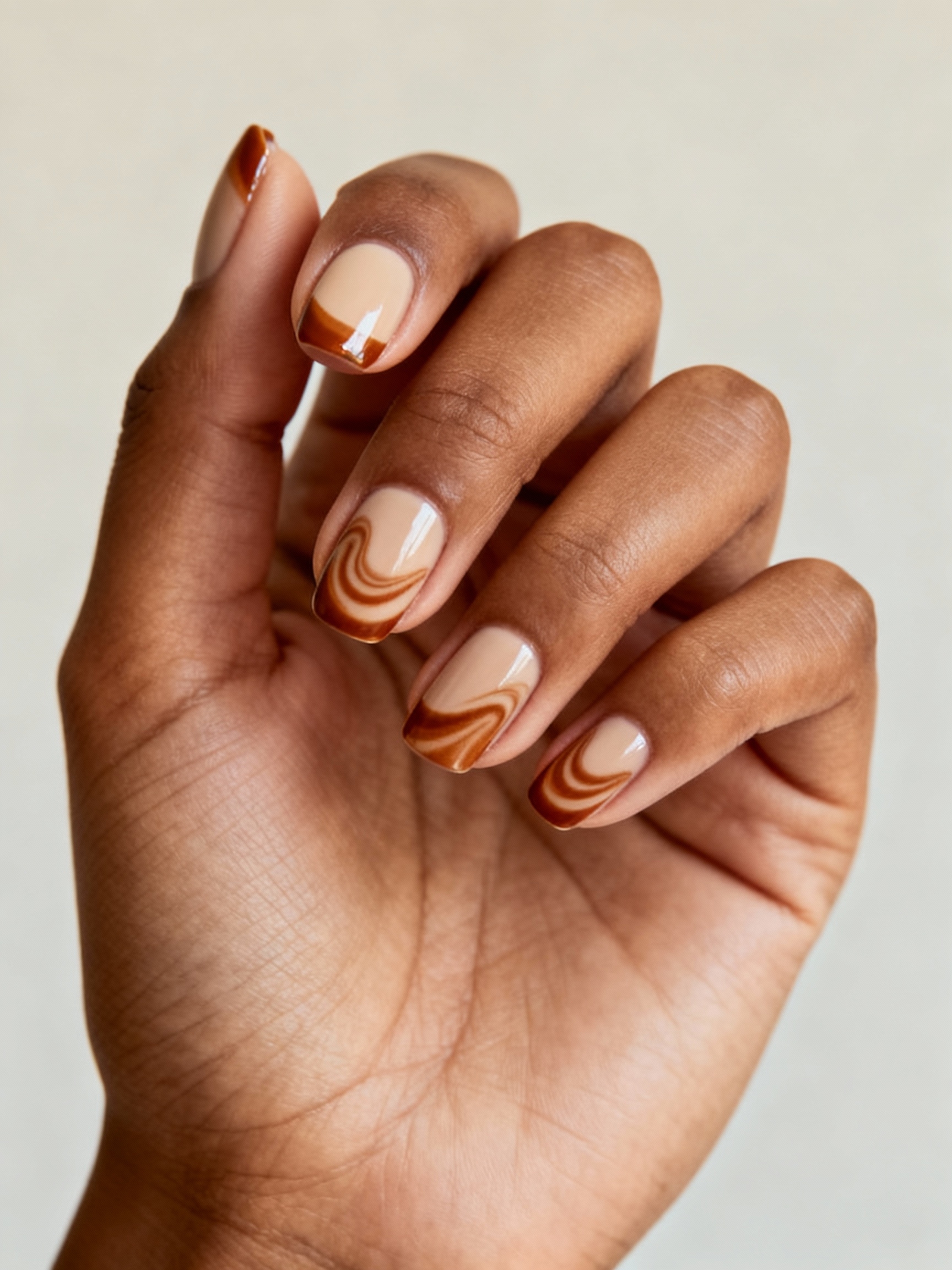 cinnamon swirled nude glossy manicure
