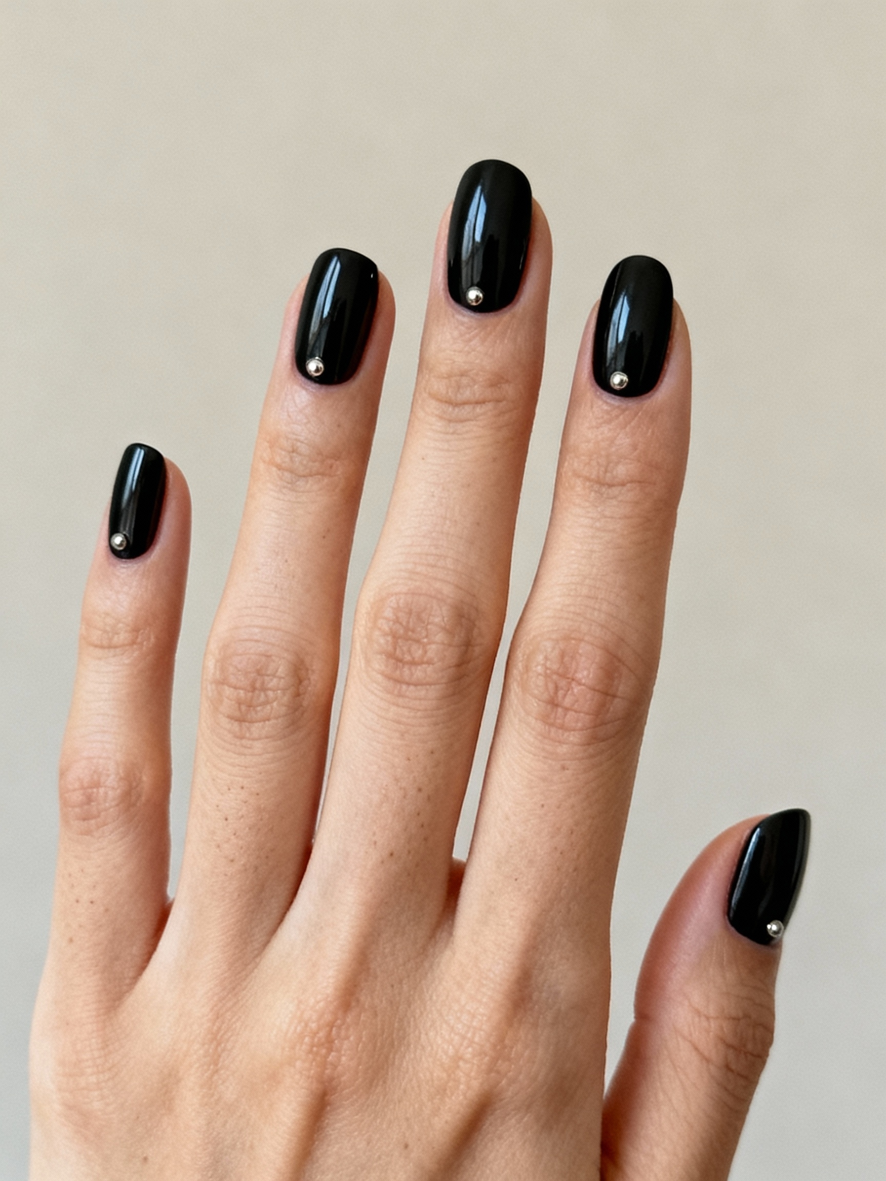 sleek black nails with studs